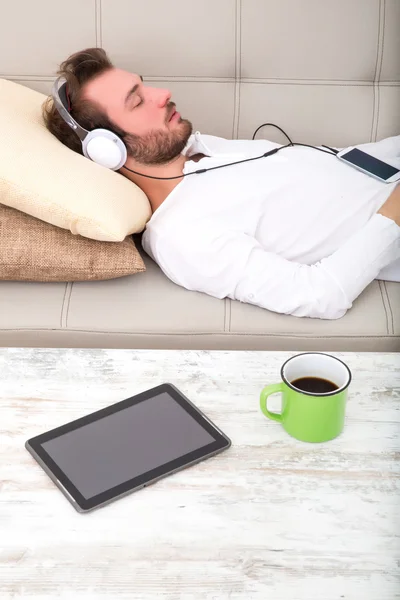 Op de Bank met koptelefoon — Stockfoto